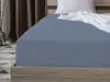 A close-up view of a blue fitted sheet on a bed. Produktbild-Vorschau