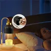 A woman sleeping in bed next to a candle warmer lamp. Náhled obrázku produktu