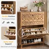 A shoe cabinet with multiple shelves and drawers, displaying shoes and decorative items. Podgląd zdjęcia produktu