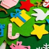 Close-up of a felt Christmas tree with various ornaments attached. Voir les images du produit