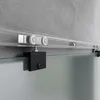 Close-up view of a sliding glass door track and roller system mounted on a concrete wall. Produktbild-Vorschau