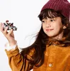 A young girl holds a small LEGO Millennium Falcon model with a Han Solo minifigure in her hand. Produktbild-Vorschau