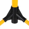 A close-up view of the base of a yellow tripod stand with black connectors. Náhled obrázku produktu
