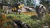 A chaotic scene from a video game with a yellow vehicle overturned, two rhinos, and a person in the foreground holding a gun. Produktbild-Vorschau