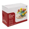 The image shows the packaging of a baby fine motor training toy, a hedgehog with colorful "spikes". Náhľad obrázku produktu