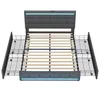 A top-down view of a gray upholstered bed frame with a slatted wooden mattress support and integrated LED lighting. Produktbild-Vorschau