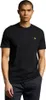 A man wearing a black t-shirt and patterned trousers. Produktbild-Vorschau