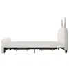A side view of a white upholstered bed frame with a cartoon rabbit-shaped headboard, shown against a white background. Voir les images du produit