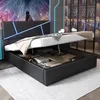 A modern black bed with LED lighting on the headboard, shown with the storage compartment open and filled with folded linens. Produktbild-Vorschau