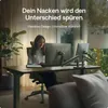 A woman is working at a desk with two monitors in a well-lit home office environment. Produktbild-Vorschau