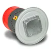 A close-up, angled view of an electric grain mill with a red and gray body, resting on a white background. The mill has a silver-colored metal grate on top and a yellow and green switch. Náhľad obrázku produktu