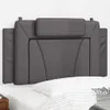 A close-up view of a gray headboard cushion placed on a bed. Produktbild-Vorschau