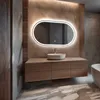 A modern bathroom vanity with a sink and an illuminated oval mirror. Produktbild-Vorschau