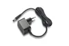 A black power adapter with a European plug and a coiled cable with a DC connector, isolated on a white background. Anteprima dell’immagine prodotto