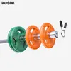A set of weight plates and barbell clips on a white background. Produktbild-Vorschau