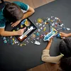 Two children are playing with LEGO space exploration toys on a table, using a tablet for guidance. Produktbild-Vorschau