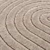A close-up view of a textured rug with a concentric circular pattern. Podgląd zdjęcia produktu