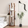 A wooden coat rack with shelves is shown next to a bed and a plant in a room. Náhľad obrázku produktu