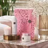 A collection of Rituals The Ritual of Sakura products arranged on a marble surface with decorative elements. Produktbild-Vorschau