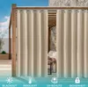 Outdoor curtains hanging on a wooden pergola structure, with a stone wall and furniture visible in the background. Produktbild-Vorschau