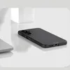 A black phone case is shown on a reflective surface with a white block in the background. Produktbild-Vorschau