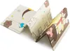 A folded baby play mat with cartoon illustrations. Produktbild-Vorschau