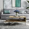 A living room scene with a couch, coffee table, and artwork. Náhled obrázku produktu