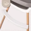 Close-up of a high chair component with an icon indicating footrest adjustment. Voir les images du produit