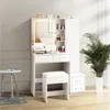 A white vanity set with a lighted mirror, drawers, and a stool, placed in a room with a plant and a small table. Produktbild-Vorschau