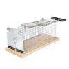 A metal cage trap with a wooden base, set against a white background. Produktbild-Vorschau
