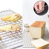 A split image showing cookies on a cooling rack on the left and a loaf of bread on a cooling rack on the right. Produktbild-Vorschau