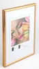 A framed picture of a woman with colorful makeup and macarons. Produktbild-Vorschau