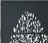 A close-up of a black metal garden gate with a white tree design cut out. Produktbild-Vorschau