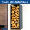 A black metal firewood rack filled with logs, mounted on a wall next to a fireplace. Produktbild-Vorschau