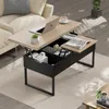 A modern living room with a coffee table in the center, featuring a laptop and books. Produktbild-Vorschau