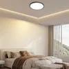 A bedroom with a bed, pillows, and a ceiling lamp. Voir les images du produit