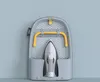 A Joseph Joseph folding ironing board with an iron stored on it, mounted on a light blue wall. Náhľad obrázku produktu