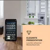 A wine cooler in a modern living space next to a table with apples and cups. Produktbild-Vorschau