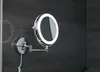 A lighted makeup mirror mounted on a dark tiled wall. Produktbild-Vorschau
