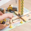A child's hands playing with a wooden construction toy set on a play mat. Voir les images du produit