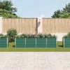 A row of green metal raised garden beds with plants growing in them, set against a wooden fence and a paved walkway. Podgląd zdjęcia produktu