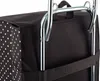 A close-up view of the top section of a black shopping bag with white polka dots, attached to a silver metal frame. Anteprima dell’immagine prodotto