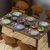 A dining table set with plates, bowls, and cutlery, arranged for a meal. Náhled obrázku produktu