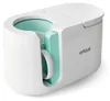 A white Cricut Mug Press with a teal interior, holding a white mug. Náhľad obrázku produktu