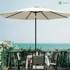 A balcony setting with a table and chairs under a large umbrella, overlooking the ocean. Produktbild-Vorschau