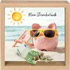 A piggy bank on a beach with money and a beach chair. Produktbild-Vorschau