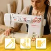 A woman is using a sewing machine, with icons representing sewing accessories at the bottom. Podgląd zdjęcia produktu