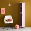 A pink metal locker stands open next to a white office chair with a pink basket on it. A pink knot pillow is on the floor. Produktbild-Vorschau
