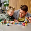 A father and daughter are playing with LEGO bricks on the floor, building various animals and vehicles. Produktbild-Vorschau