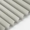 A close-up, angled view of folded pleated blinds. Produktbild-Vorschau